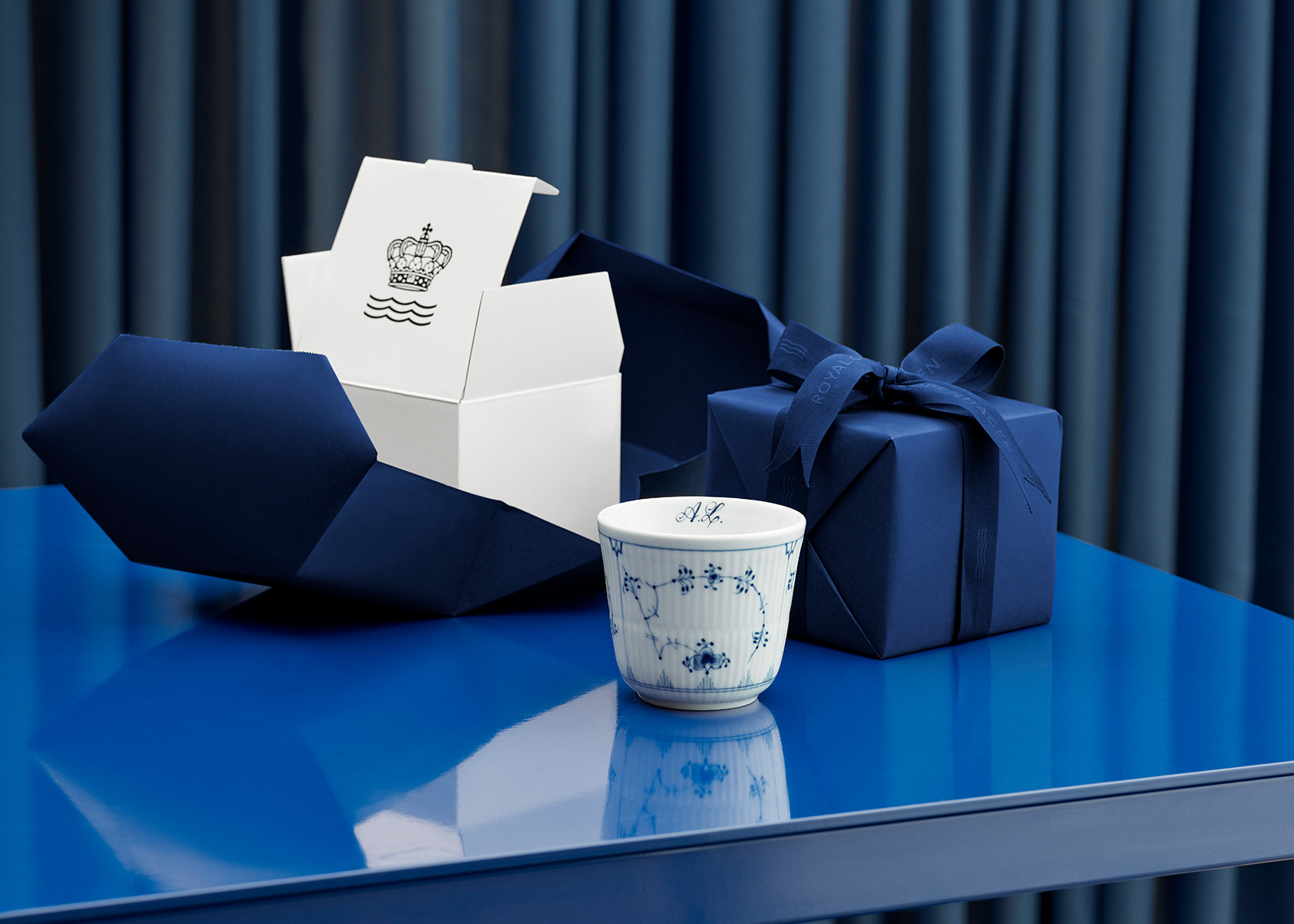 A Blue Fluted Plain Thermal Mug 26 cl is ready to be packed and gift wrapped for a birthday gift